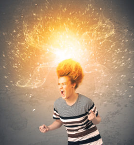 Young woman with energetic exploding red hair